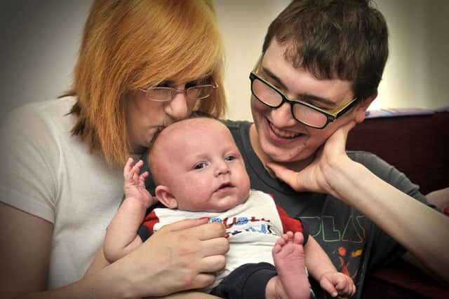 A tender moment. Baby Alfie McKenna Taylor with Mum Jananine Mackenna and Dad Robert Taylor look towards a brighter future with baby Alfie. pic Richard Ponter 152711c