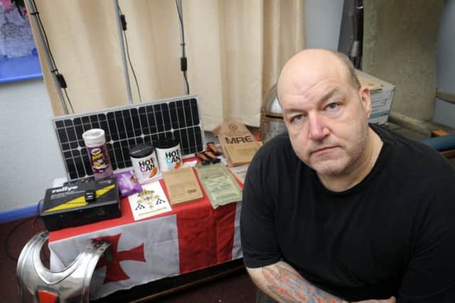 Russ Kellett, at his Filey home, makes plans to survive the apocolypse on December 21st, with solar panel electricity, and self heating foods. Photo by Andrew Higgins 124944a 07/12/12