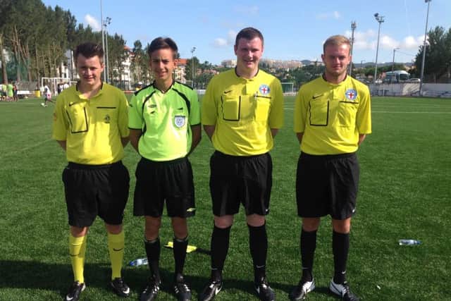 George Roberts, second right, with his fellow refs