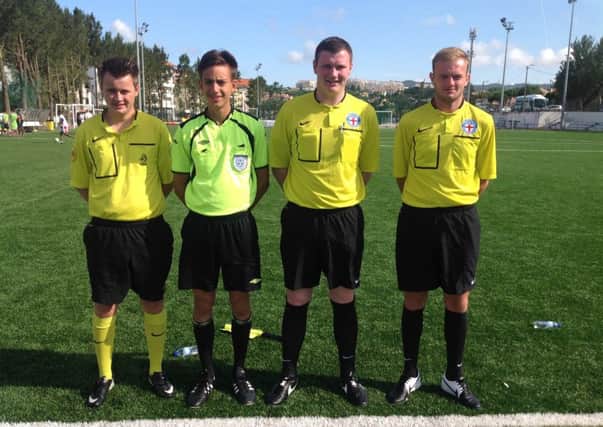 George Roberts, second right, with his fellow refs