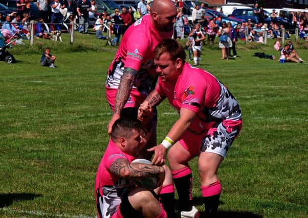 Members of Pirates A help their try scorer to his feet. 152049j