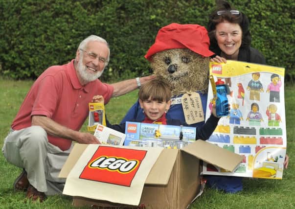 Muston Village Hall .Harry Amstell gets some Lego gifts..presented by Muston Scarecrow Chairman Godfrey Allanson and Stacy Dodd . Pic Richard Ponter 153204a