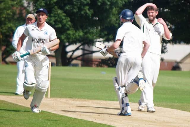 Scarborough 3rds batsmen cross for a single as Thornton Dale bowler Colin Lockwood shows his frustrations. Picture: Steve Lilly