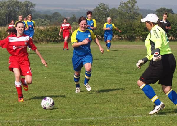 Aimee Ireland charges down the ball with the Brayton Belles keeper quickly out of her box to clean up the pressure. Pictures: Steve Lilly