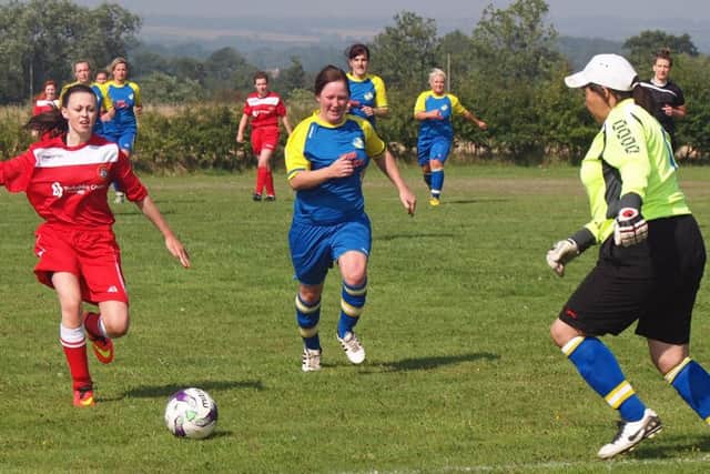 Aimee Ireland charges down the ball with the Brayton Belles keeper quickly out of her box to clean up the pressure. Pictures: Steve Lilly