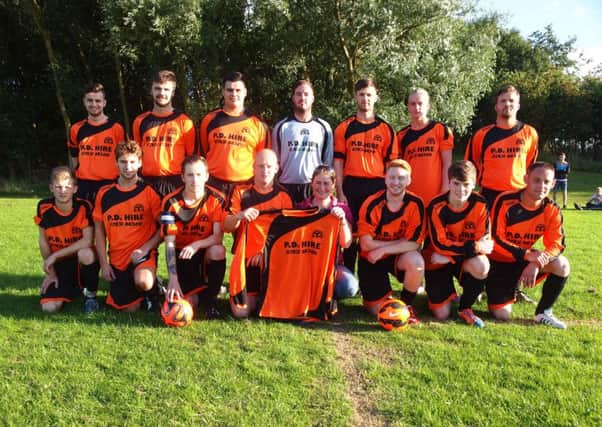 Hunmanby United  Reserves line up in their new kit  with Hayley Wedge of sponsors P.D Hire			                                      Picture: Steve Lilly