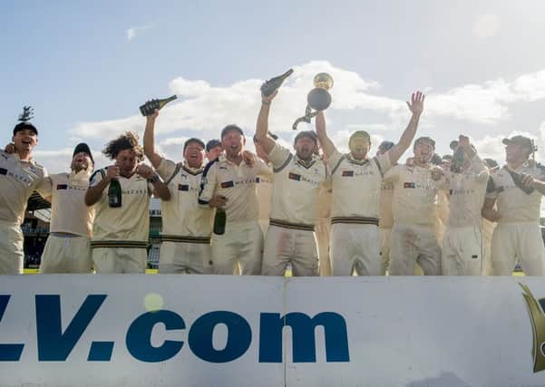 Yorkshire's captain Andrew Gale holds the LV County Championship trophy aloft as his team celebrates victory. Picture: SWPIX.COM