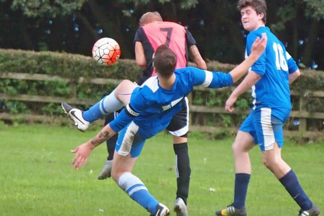 Commercial Skipper Josh Dolan attempts to stop a goalbound Sam Braodbent.It Is It Is Rovers V Commercial @Olivers Mount 152101g