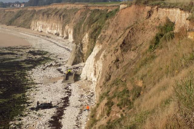 The scene after a car was driven over the edge of the cliff at Sewerby