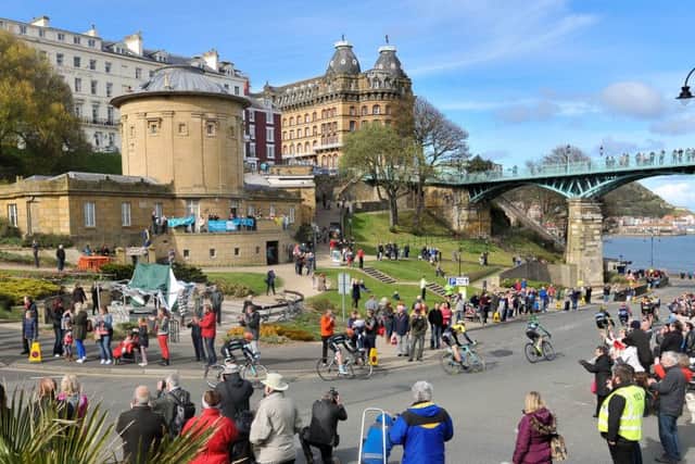 TOUR DE YORKSHIRE 2015 --- Final section through Scarborough town centre on Stage 1 of the first Tour De Yorkshire bike race. // Riders make their way under the Spa Bridge past the Rotunda Museum. Friday 1st May 2015. HARRY ATKINSON REF: