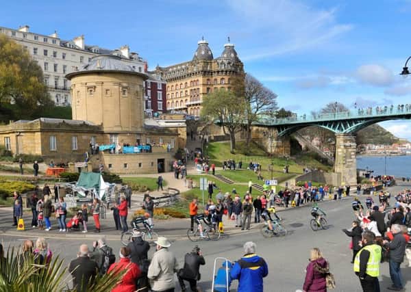 TOUR DE YORKSHIRE 2015 --- Final section through Scarborough town centre on Stage 1 of the first Tour De Yorkshire bike race. // Riders make their way under the Spa Bridge past the Rotunda Museum. Friday 1st May 2015. HARRY ATKINSON REF: