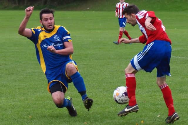 Filey's Ben Briggs is heading for the officials black book. 152117f.Hunmanby V Filey Town Scarborough News Saturday League Division One Saturday 17-10-15@Sands Lane