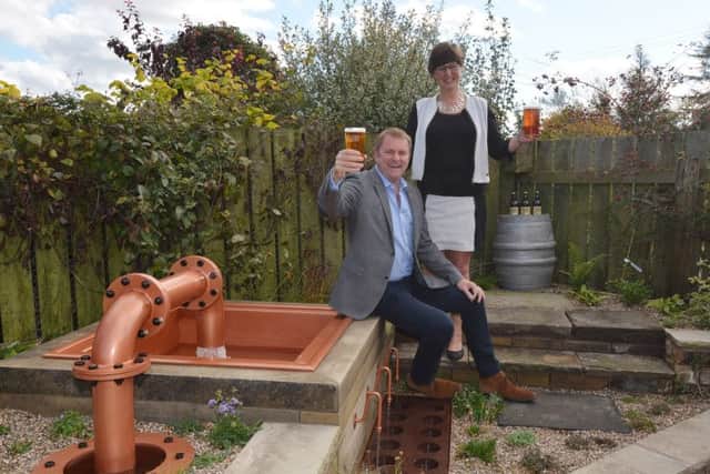 Welcome to Yorkshires Sir Gary Verity,  left , with Gill Mellor, director of Wold Top brewery, and the water feature.