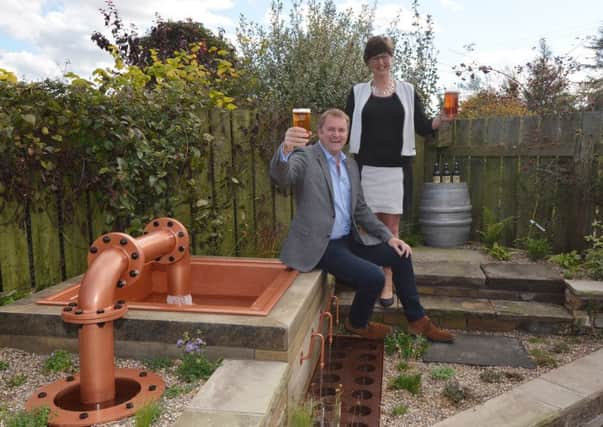 Welcome to Yorkshires Sir Gary Verity,  left , with Gill Mellor, director of Wold Top brewery, and the water feature.