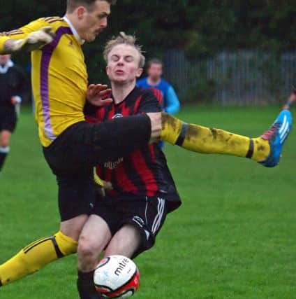 The Ayton keeper Shaun Dolan rushes out of his area to clear the danger from Piers Chris Weetman. 152127b.Ayton v West Pier Res, Scarborough News Saturday League Division Two 14-11-15@Wilsons Lane.