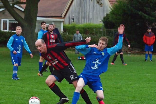 Ray Thorpe holds off Jamie Millar of Ayton. 152127c.Ayton v West Pier Res, Scarborough News Saturday League Division Two 14-11-15@Wilsons Lane.