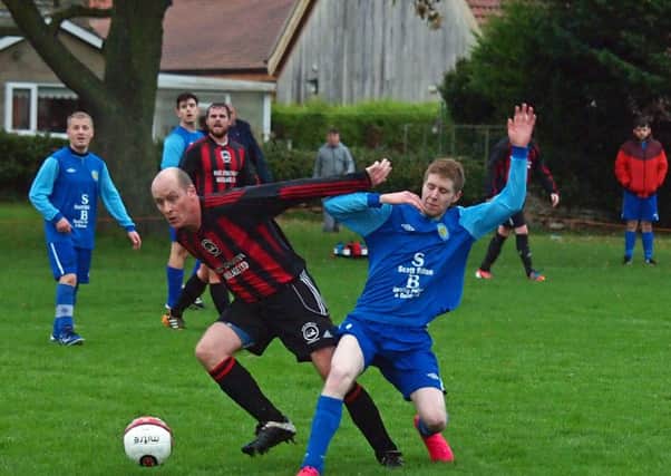 Ray Thorpe holds off Jamie Millar of Ayton. 152127c.Ayton v West Pier Res, Scarborough News Saturday League Division Two 14-11-15@Wilsons Lane.