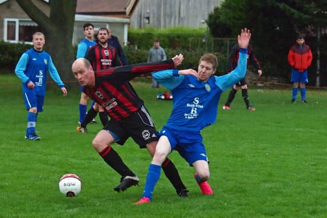 Ray Thorpe (West Pier Reserves, red and black kit) tangles with Ayton's Jamie Millar 152127c.Ayton v West Pier Res, Scarborough News Saturday League Division Two 14-11-15@Wilsons Lane.