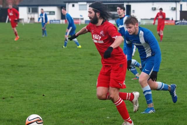 Filey Town Reserves' James Jenkinson leaves Commercial's Luke Beaver in his tracks during their 6-1 Junior Cup success. Picture: Steve Lilly