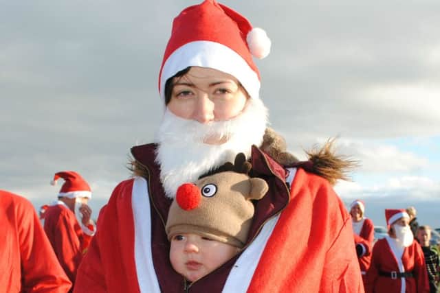 Flashback to last years Santa Dash with Alexander Knowles snuggled up with mum Kathryn.