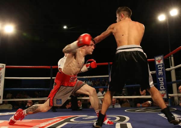 Shaun Ireland throws a right hand against Ryan Hanson. Picture: Lesley Pickersgill.