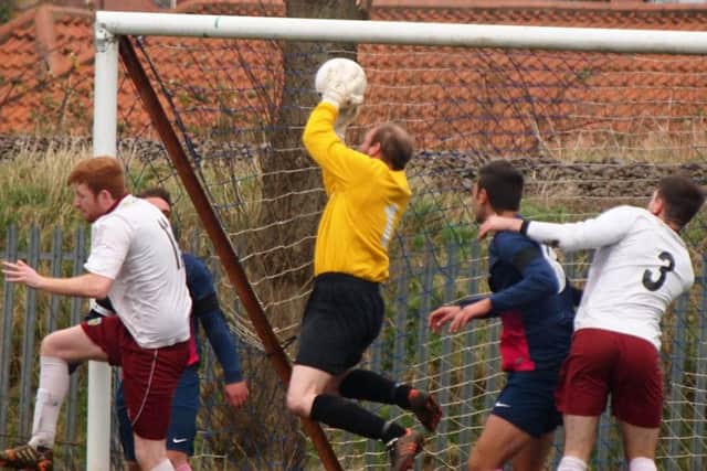 Traf keeper Chris Garton safely collects from a Ayton corner.152138c.