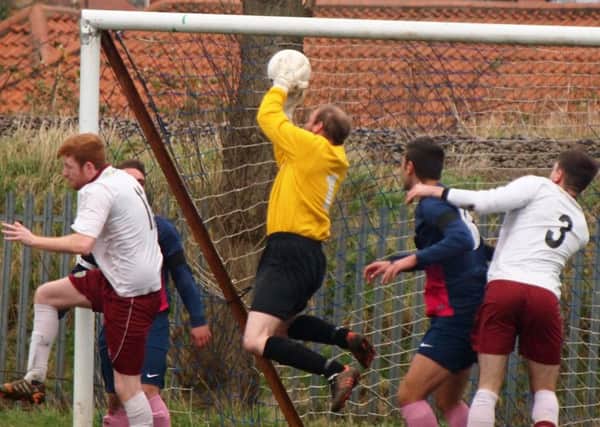 Traf keeper Chris Garton safely collects from a Ayton corner.152138c.