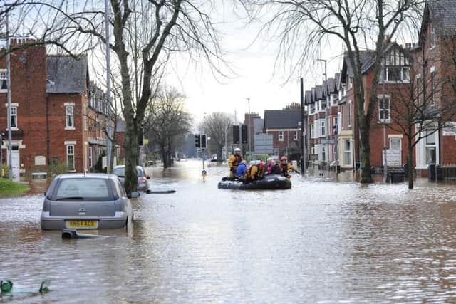 Fire and Rescue teams bring people out of flooded homes in Carlisle following heavy rains over he weekend.