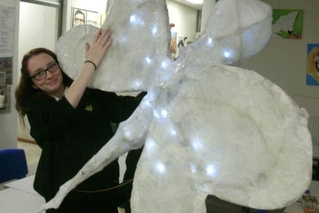 Evie Wright pictured with one of the sculptures.