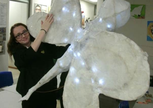 Evie Wright pictured with one of the sculptures.