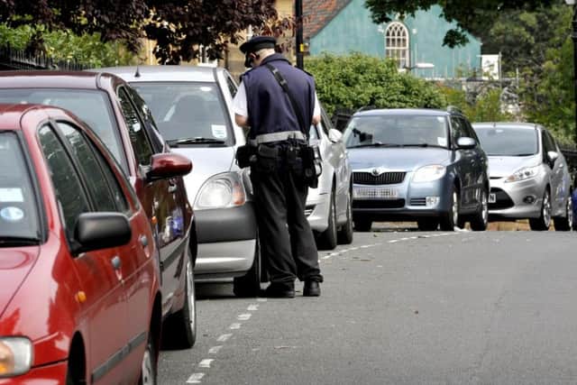 File pic - A Scarborough Council Parking Attendant working in The Crescent. 093357v
pic Andrew Higgins 14/08/09
in News
ticket
car parking
civil enforcement officer
warden
