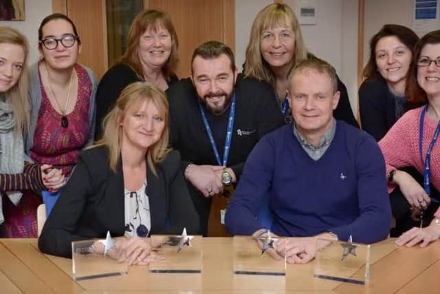 Yorkshire Coast Homes Chief Executive Shaun Tymon (front,right) and Assistant Director of Community Services Debbie Gordon (front, left) celebrate with Amie Stonehouse, Jody Smith, Carole Proctor, Kevin Bradshaw, Deborah McKellar, Angela Starkey and Donna Shaw.