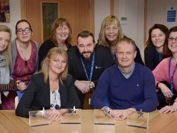 Yorkshire Coast Homes Chief Executive Shaun Tymon (front,right) and Assistant Director of Community Services Debbie Gordon (front, left) celebrate with Amie Stonehouse, Jody Smith, Carole Proctor, Kevin Bradshaw, Deborah McKellar, Angela Starkey and Donna Shaw.