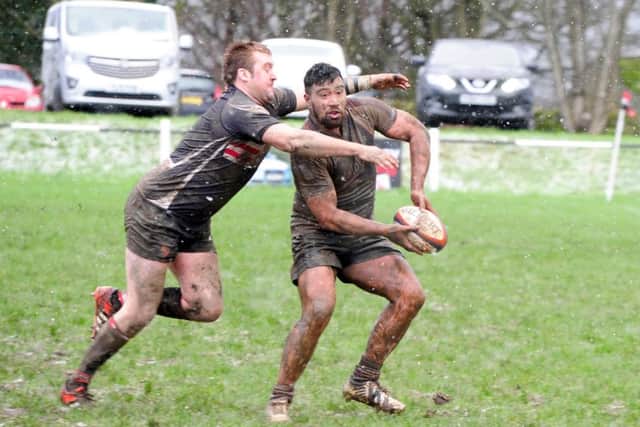 Isaac Faamau offloads under pressure from an Old Brods man