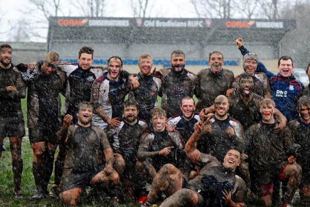 Scarborough RUFC caked in mud following their win at Old Brodleians