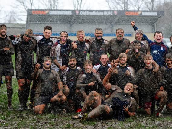 Scarborough RUFC caked in mud following their win at Old Brodleians