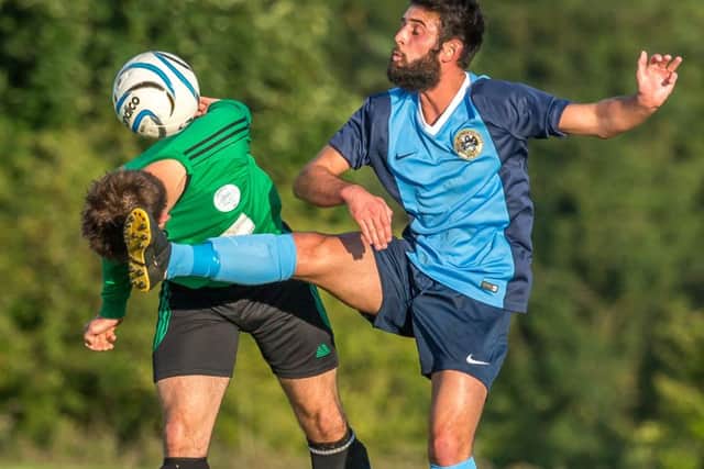 Whitby Fishermen, blue kit, tackle Itis Itis Rovers in the North Riding Saturday Challenge Cup