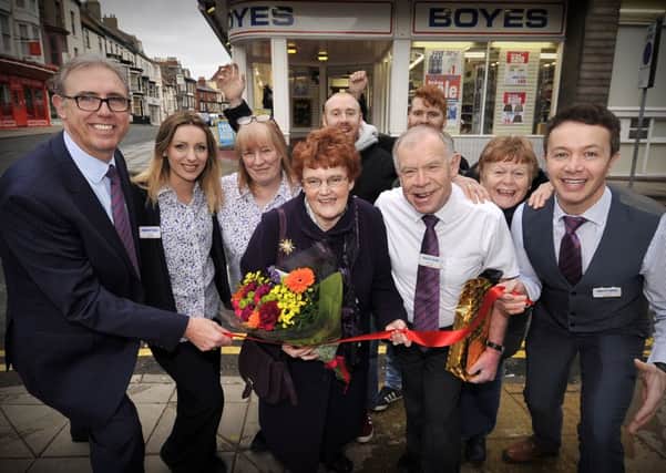 After fifty years service for Boyes Ian Livingstone cuts the tape for the Boyes grand sale...Ernie Gee of Boyes  ,Eileen Livingstone, Ian,Chris Golder pictured with staff and Ian's family. pic Richard Ponter 160523