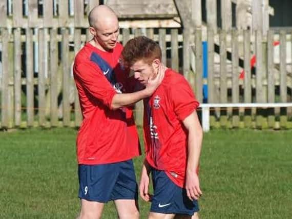 Mike Grayshan congratulates Tyson Stubbings after he opened the scoring for Ayton in their 7-0 win at home to Barrowcliff Reserves. Picture: Steve Lilly
