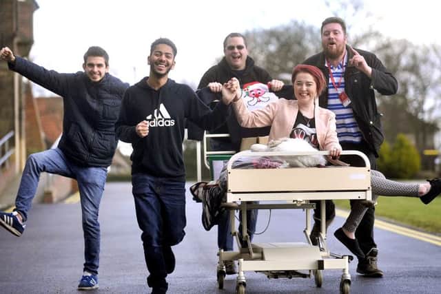 University campus students with the fundraising bed.