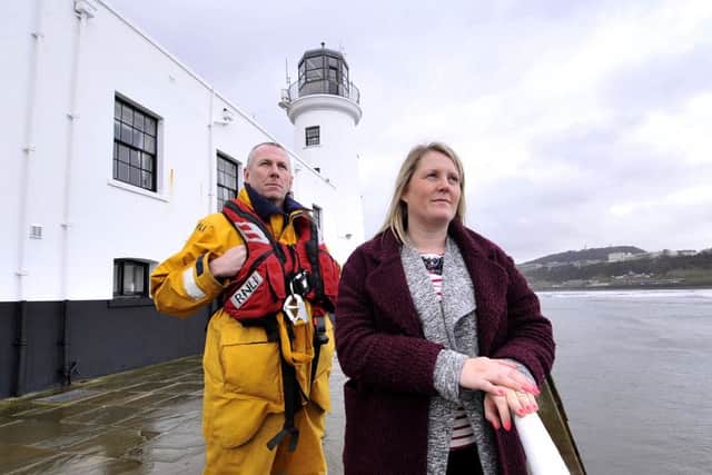 Reflecting on the death of her Brother Andrew McGeown . Donna Loveland and Scarboroughs RNLI Station Mechanic Dave Horsley look out on the Scarborough coast . pic Richard ponter 160703c