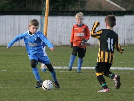 Heslerton under-eights in action against Scalby Stags