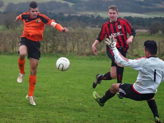 Billy Logan, red and black stripes, in action against Edgehill last month, struck three goals for West Pier in their 6-1 defeat of Seamer Sports