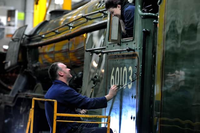 Date:17th February 2016. Picture James Hardisty.
Mike O'Connor, from the Heritage Painting Team at the National Railway Museum, York, painting the number on the side of Flying Scotsman cab, watch by daughter Teriann, aged 21, showing its new post-restoration guise as 60103.The locomotive will be transformed from business-like black to it's gleaming green, ready for its official return to steam along the East Coast Mainline, the Inaugural Run on 25th February.