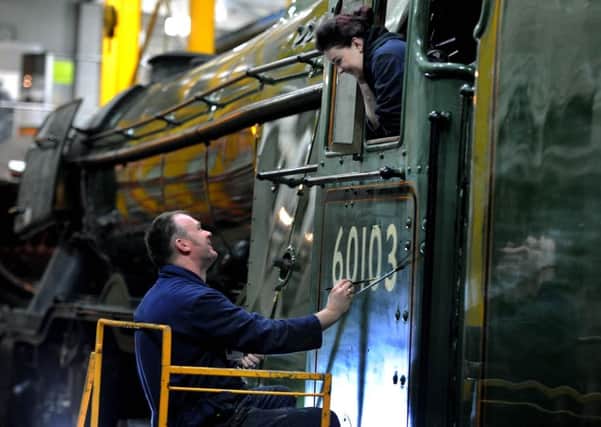Date:17th February 2016. Picture James Hardisty.
Mike O'Connor, from the Heritage Painting Team at the National Railway Museum, York, painting the number on the side of Flying Scotsman cab, watch by daughter Teriann, aged 21, showing its new post-restoration guise as 60103.The locomotive will be transformed from business-like black to it's gleaming green, ready for its official return to steam along the East Coast Mainline, the Inaugural Run on 25th February.