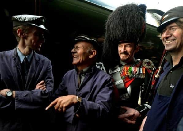 The crew that brought Flying Scotsman into York station, left to right, Jim Clarke (Fireman), Jim Smith (Footplater superintendent) and Steve Hanczao (Driver) in the background is Piper David Watertoon-Anderson who piped in the steam engine. (GL1009/09q)