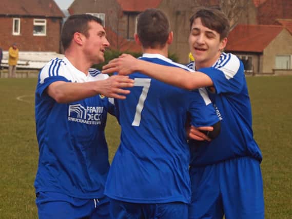 Edgehill Reserves celebrate with goalscorer Tom Scales (centre) during their 3-0 semi-final win at Duchess. Pictures: Steve Lilly.