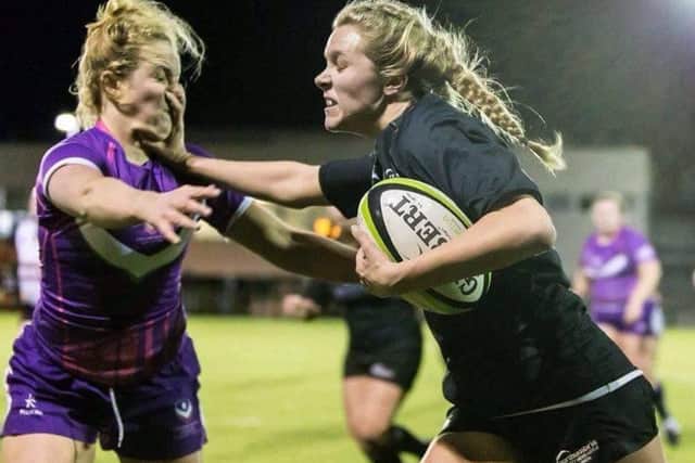 Zoe Aldcroft hands off an opponent
