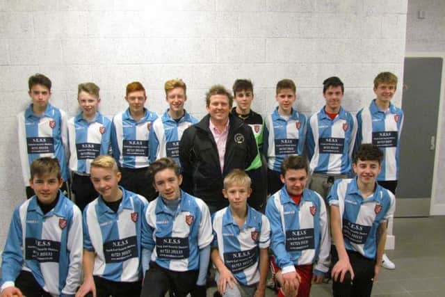 Luke Jennison of sponsors North East Security Shutters with the Scarborough Athletic under-15s in their new kit