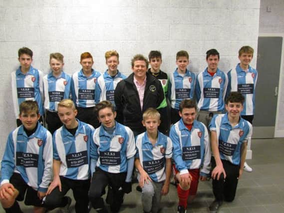 Luke Jennison of sponsors North East Security Shutters with the Scarborough Athletic under-15s in their new kit